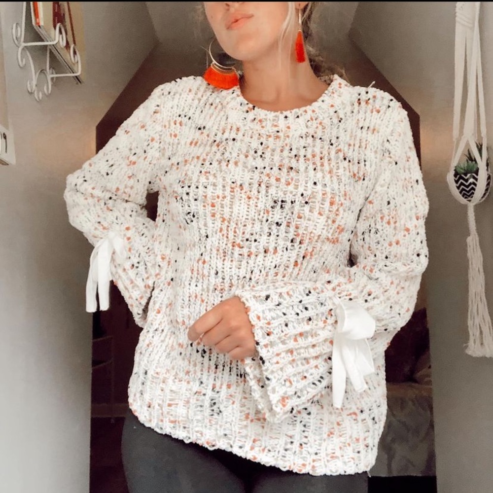 white sweater w/ color throughout & bows on sleeves